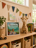 kindergarten friendship book with cute baby animals on front cover like lion, elephant, giraffe, sparling, bat, snake, meerkat displayed on childrens shelf next to pencils and puzzles. By memories that matter. cuddly toy and garland next to it. 