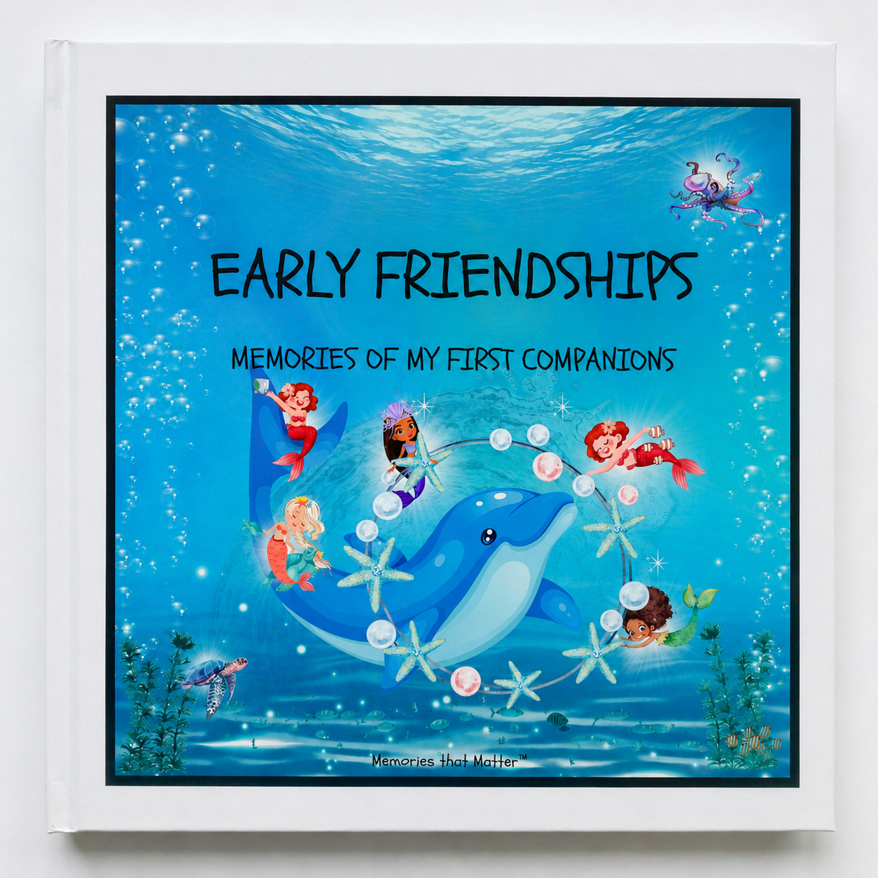 kindergarten friendship book titled 'Early Friendships - Singing with Mermaids' with cartoon mermaids, a dolphin, turtle, shells, bubbles, octopus. square book, black frame, white rim. 